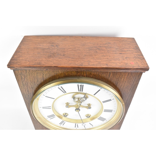 68 - A late 19th century oak cased mantle clock, the white enamel dial having Roman numerals, Breguet sty... 