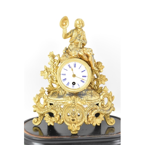 84 - A late 19th century French gilt metal mantle clock and dome, the case fashioned as a gent seated ato... 