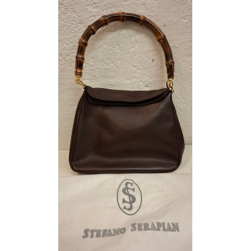 34 - Serapian- A vintage Stefano Serapian soft brown leather hand bag with bamboo handle and gold tone ha... 