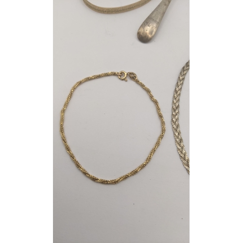 111 - A mixed lot to include a silver teaspoon, two silver necklaces and a gold plated bangle, together wi... 