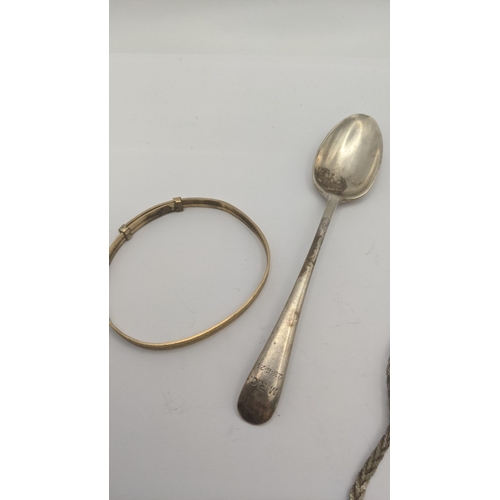 111 - A mixed lot to include a silver teaspoon, two silver necklaces and a gold plated bangle, together wi... 