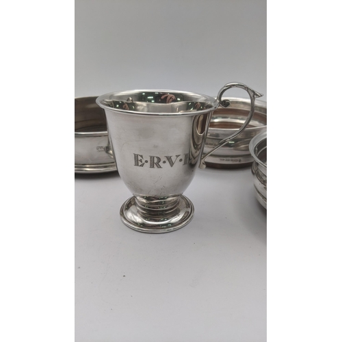 118 - A mixed lot of silver to include three wine coasters along with a christening cup engraved E.R.V.L h... 