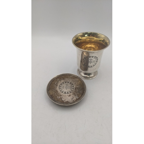 13 - A silver two piece communion set hallmarked London 1832 with a bell shaped rounded body and gilt int... 