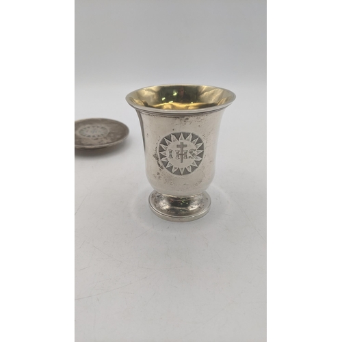 13 - A silver two piece communion set hallmarked London 1832 with a bell shaped rounded body and gilt int... 