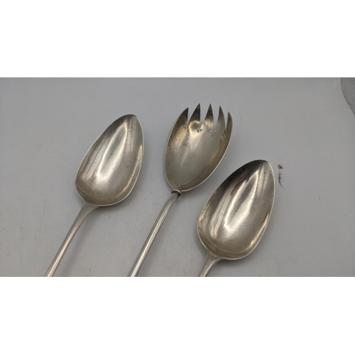 14 - Silver to include a salad server marked London 1902, together with a pair of serving spoons hallmark... 