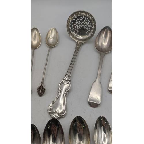 15 - Silver comprising of a sugar shifter a group of silver tea mixed tea spoons, along with two 800 silv... 