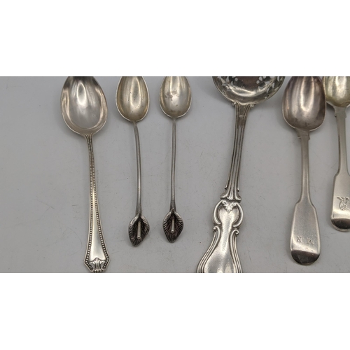 15 - Silver comprising of a sugar shifter a group of silver tea mixed tea spoons, along with two 800 silv... 