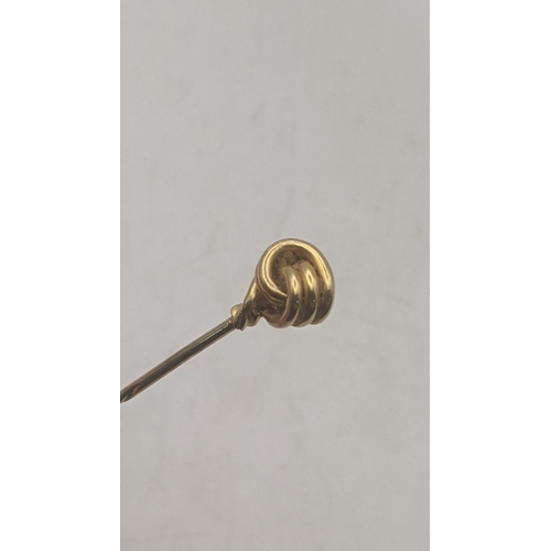 23 - A yellow metal stick pin, pental tested as 18ct yellow gold, pin tested as 14ct yellow gold, total w... 