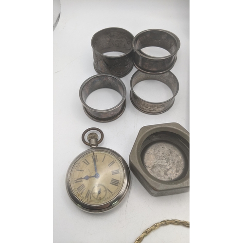 26 - A mixed lot to include a group of 5 silver napkin rings 73.2g, silver plated tea spoons, a keyless o... 