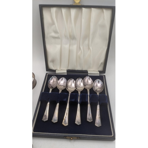 26 - A mixed lot to include a group of 5 silver napkin rings 73.2g, silver plated tea spoons, a keyless o... 