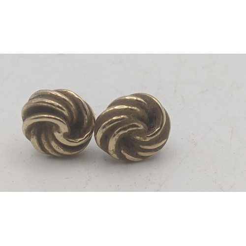 31 - A pair of yellow metal knot style stud earrings, tested as 9ct gold 1g, together with a yellow gold ... 