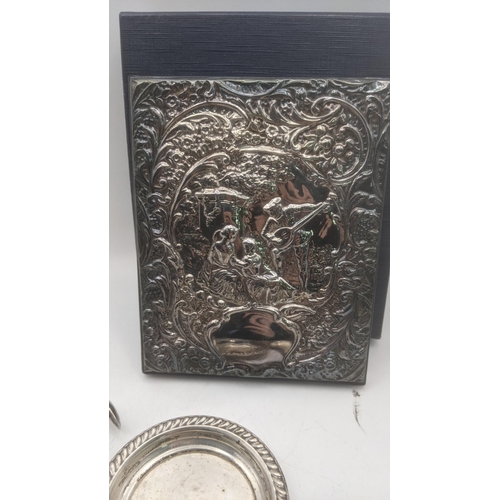 37 - A mixed lot to include a silver fronted address book having an embossed design depicting figural and... 