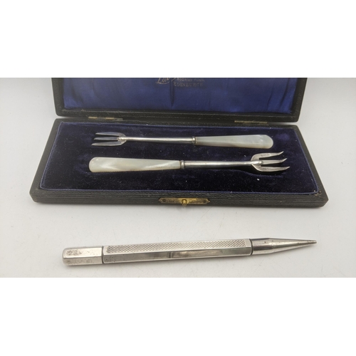 41 - Silver to include a vesta case a propelling pencil, two spoons the handles made from coins, and two ... 