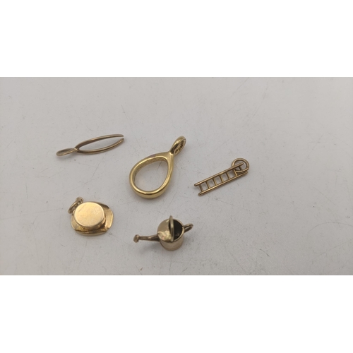 60 - Four 9ct yellow gold charm bracelets to include a wishbone, top hat, ladders and watering can 2.6g, ... 