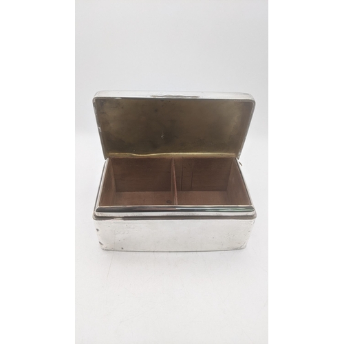 62 - A silver cigarette box having engraved initials to the lid and a gilt and wood lined interior, 7.5cm... 