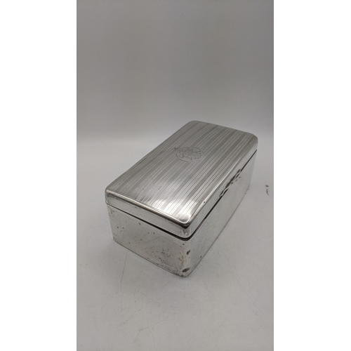 62 - A silver cigarette box having engraved initials to the lid and a gilt and wood lined interior, 7.5cm... 