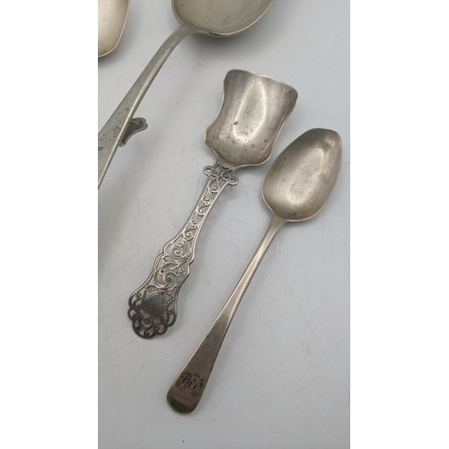 63 - A white metal Continental basting spoon, along with two teaspoons and silver caddy spoon with a flor... 