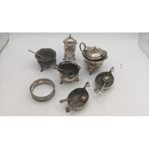 64 - A selection of silver and white metal condiment pots and spoons to include a mustard pot having a bl... 