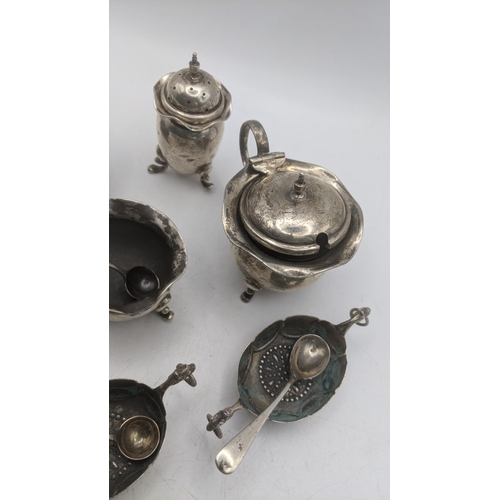 64 - A selection of silver and white metal condiment pots and spoons to include a mustard pot having a bl... 