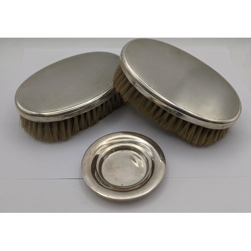 73 - Asprey of London silver to include two dressing table brushes along with a pin dish hallmarked Birmi... 