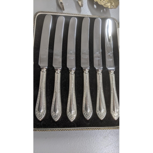 75 - Silver and white metal to include a set of six silver handled butter knives in a fitted cse, a pair ... 