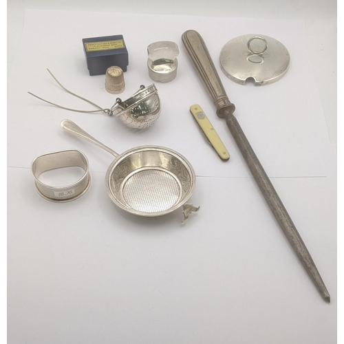 80 - Mixed silver to include two tea strainers, napkin ring, silver thimble and other items along with a ... 