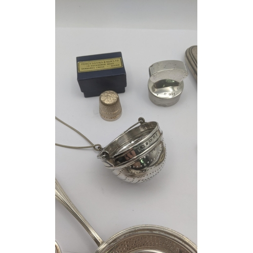 80 - Mixed silver to include two tea strainers, napkin ring, silver thimble and other items along with a ... 