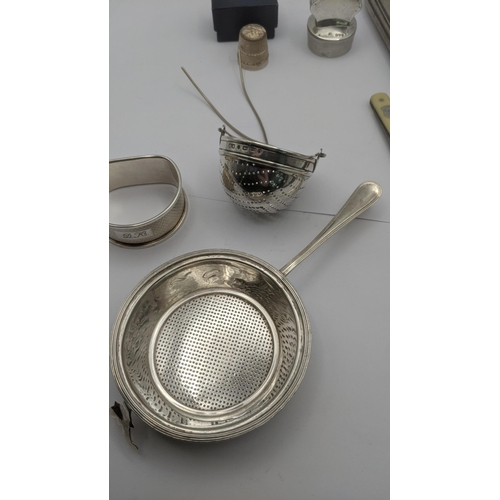 80 - Mixed silver to include two tea strainers, napkin ring, silver thimble and other items along with a ... 