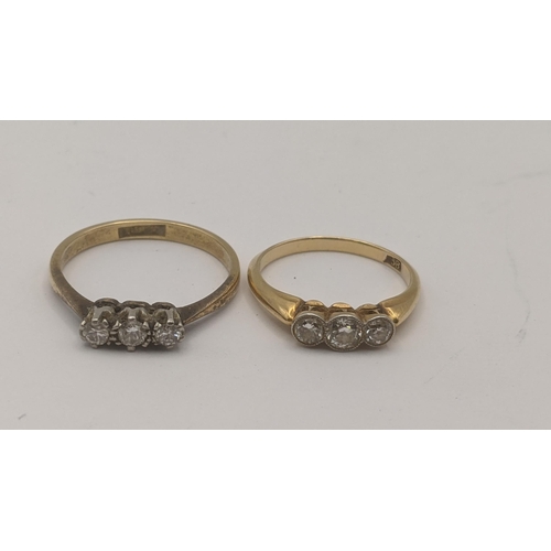 84 - Two three stone ladies diamond rings to include one in a platinum claw setting on an 18ct yellow gol... 