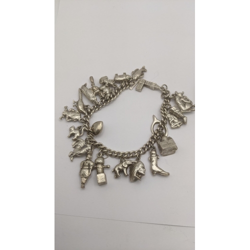 87 - Silver and white metal to include a silver charm bracelet filled with white metal charms along with ... 