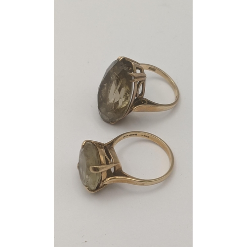 91 - Two 9ct yellow gold and quartz rings to include an oval cut lemon quartz in a four-claw setting, and... 