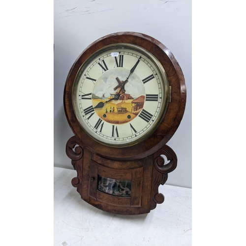 249 - Two 19th century drop dial clocks to include an American burr walnut 8-day clock, circa 1880
Locatio... 