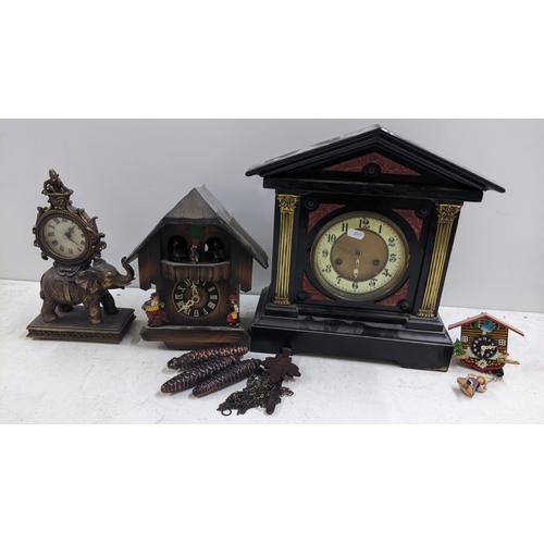 252 - Four clocks to include a mid 20th century cuckoo clock, Victorian ebonised mantel clock and others
L... 