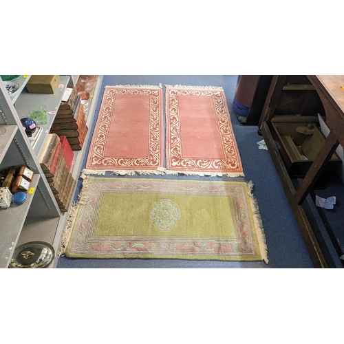 271 - Three Chinese rugs to include a green ground rug with a central motif, 140cm x 73cm, together with a... 