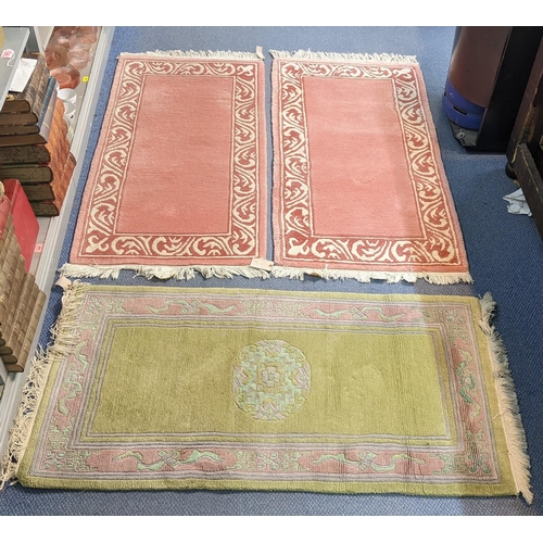 271 - Three Chinese rugs to include a green ground rug with a central motif, 140cm x 73cm, together with a... 