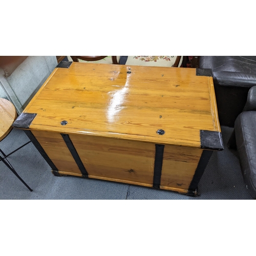 272 - A Swedish pine trunk with wrought iron supports and twin carrying handles, 59cm h x 106cm w, togethe... 