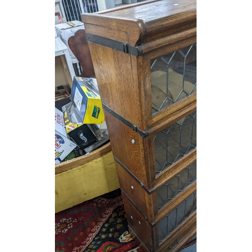 273 - An early 20th century Globe Wernicke oak graduating oak graduating four section bookcase with a draw... 