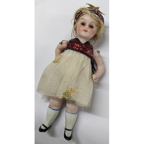 274 - A circa 1900 German miniature bisque doll, possibly Simon & Halbig, 9cm, contained in a Cadbury choc... 