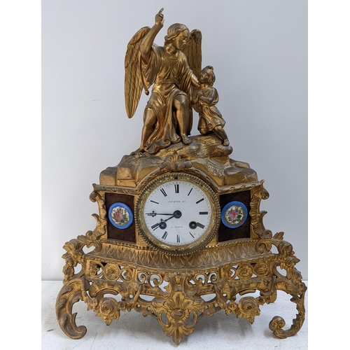 279 - A late 19th century French gilt metal 8-day mantel clock the top fashioned as an angel with a child,... 