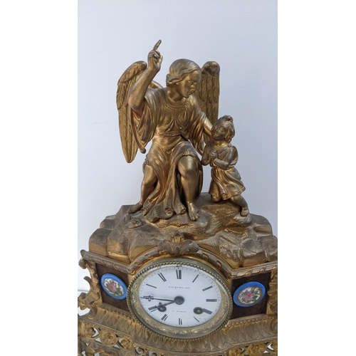 279 - A late 19th century French gilt metal 8-day mantel clock the top fashioned as an angel with a child,... 