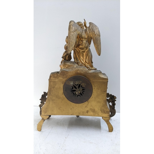 279 - A late 19th century French gilt metal 8-day mantel clock the top fashioned as an angel with a child,... 