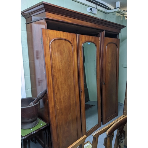 296 - Victorian mahogany triple wardrobe with central mirror on plinth base 208cm x 195cm x 63.5cm Locatio... 