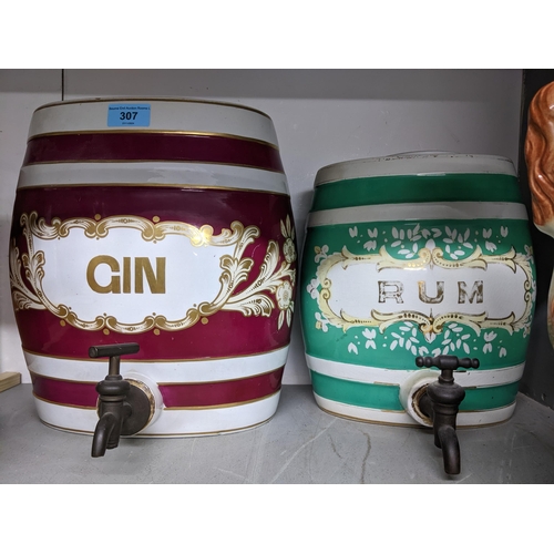 307 - Two Victorian ceramic spirit barrels for gin and rum, each with a brass top, along with a pair of St... 