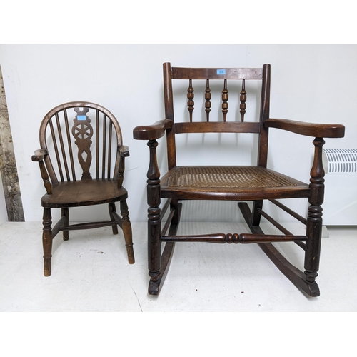 312 - A 19th century cane seated rocking chair turned spindle back out swept arms, on ring turned legs uni... 