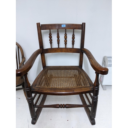 312 - A 19th century cane seated rocking chair turned spindle back out swept arms, on ring turned legs uni... 