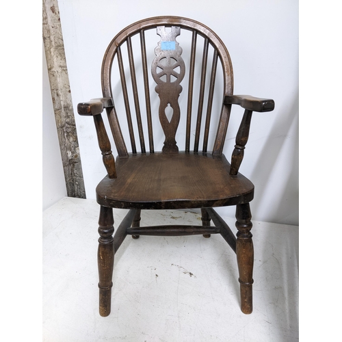 312 - A 19th century cane seated rocking chair turned spindle back out swept arms, on ring turned legs uni... 