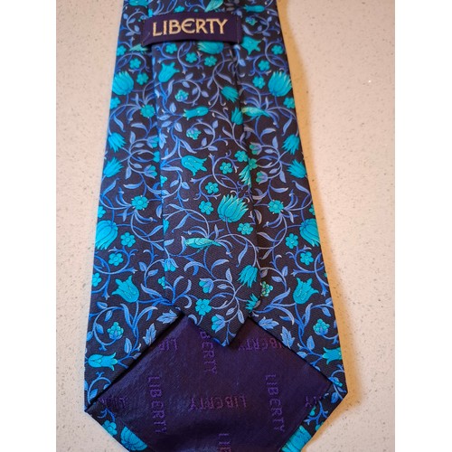 39 - Liberty- A turquoise, mid blue and navy silk tie with floral design and original branded tie slip ca... 