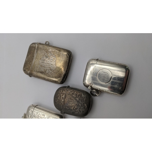 100 - A group of 5 silver vesta cases to include three floral engraved examples, and two others 
 Location... 