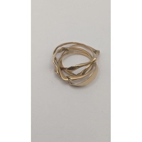 128 - An yellow metal puzzle ring tested as 9ct yellow gold with paperwork 4.8g
 Location:CAB1
If there is... 