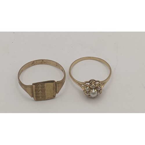 130 - Two 9ct yellow gold rings to include a seed pearl flower head example along with a gents signet ring... 